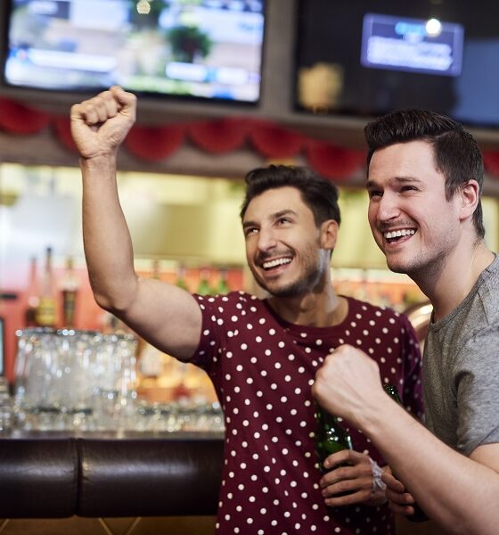 Excited men watching american football competition